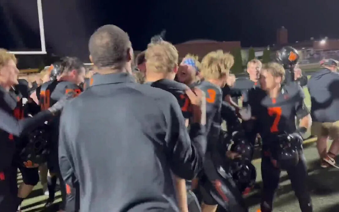 West De Pere coach Chris Greisen gets a surprise after a thrilling 48-45 win over Bay Port